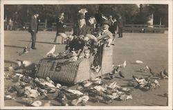 #15 wicker car, two gentlemen feeding pigeons Postcard