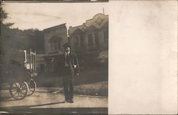 Man standing next to railroad luggage cart, Seminary Station? Postcard