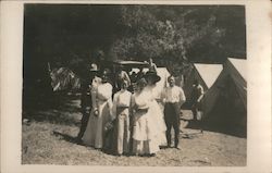 Group of people in camp with tent-cabins Postcard