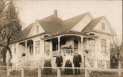 Family posing outside a wooden house with a porch Nevada City, CA Postcard Postcard Postcard