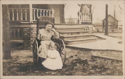 Woman in a wheelchair with a child Postcard