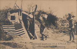 Bringing supplies to a Y.M.C.A. hut. Men in uniform carrying boxes, barrels World War I Postcard Postcard Postcard