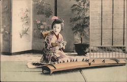 A Japanese lady playing a Koto Postcard