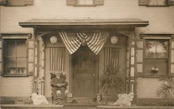 Man and dog on porch with flags Postcard