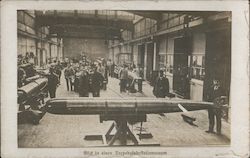 German Torpedo factory with men standing around Postcard