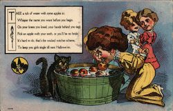 A woman and a cat bobbing for apples Halloween Postcard Postcard Postcard