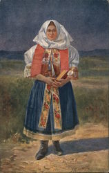 A woman in traditional Czech dress holds a book while standing in a field. Postcard Postcard Postcard