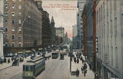 View of Main Street, looking East from Fitzhugh Street, showing buildings, people and trolleys Rochester, NY Postcard Postcard Postcard