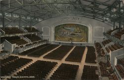 Interior view of The Forum hall showing the stage and the seating area Postcard