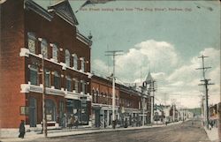 Color view of Main Street looking West from "The Drug Store" Postcard