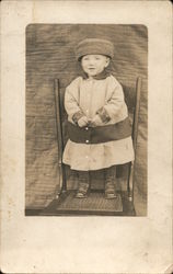 Small child standing on a chair Postcard