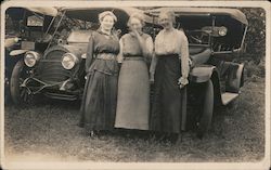 Women in Long Skirts in Front of Three Automobiles Postcard