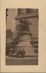 soldiers sitting crosslegged under imposing statue World War I Postcard Postcard Postcard