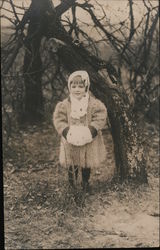 Child in wooly coat and fur muff under tree Postcard