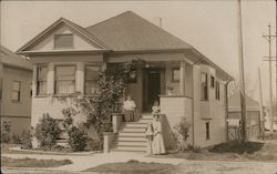 Family on Steps of House Postcard