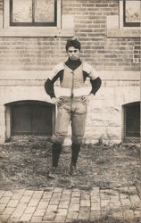 Football Player in Front of Brick Building Postcard