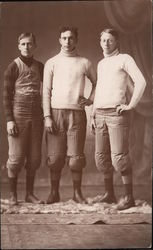 Three Football Players in Sweaters and Knee Pads Postcard