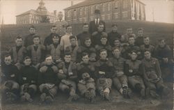 College Football Team Seated in Grass Postcard