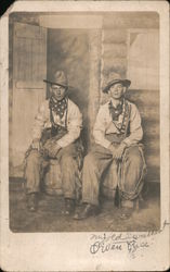 Two Men dressed as Cowboys outside a Log Building Studio Photos Postcard Postcard Postcard